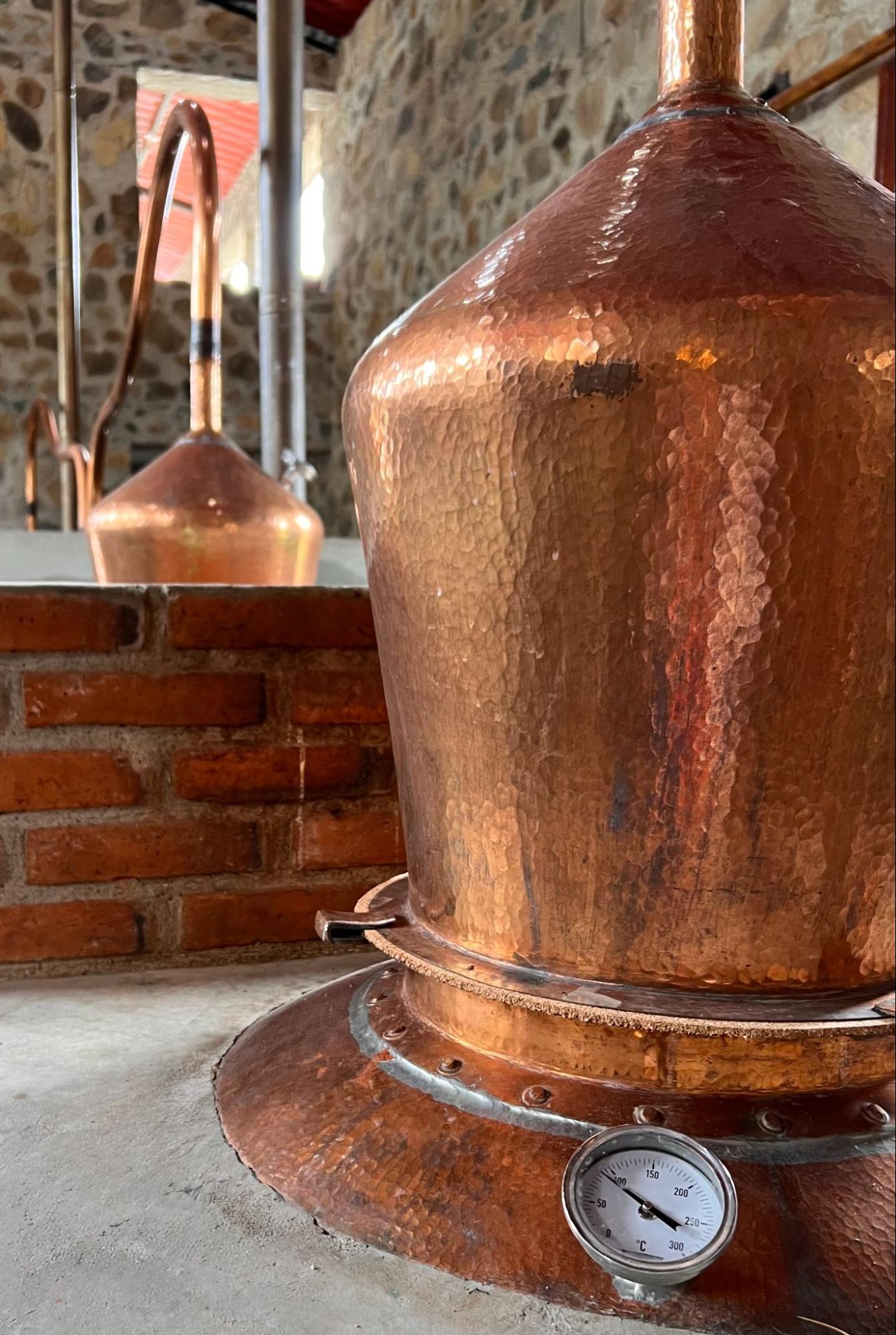 Hand-hammered copper still at Mezcal Argato with temperature gauge